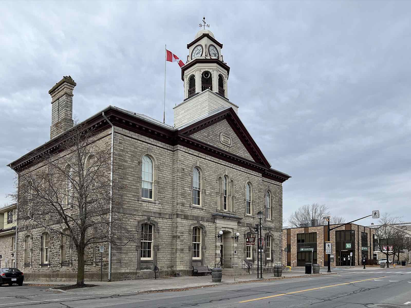 Stone town hall with a Canadian flag on the clock tower